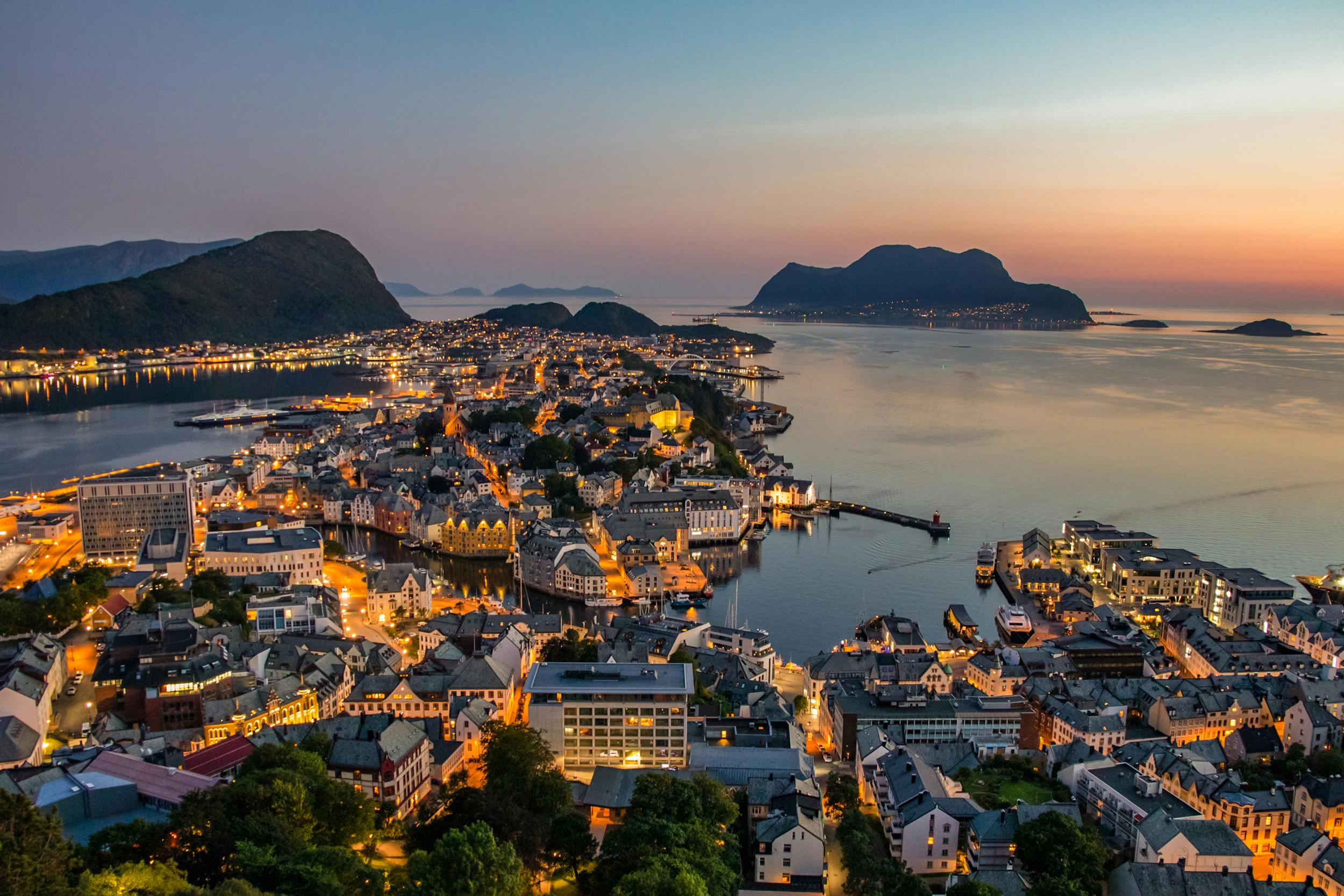 Coastal city at dusk with islands and calm water